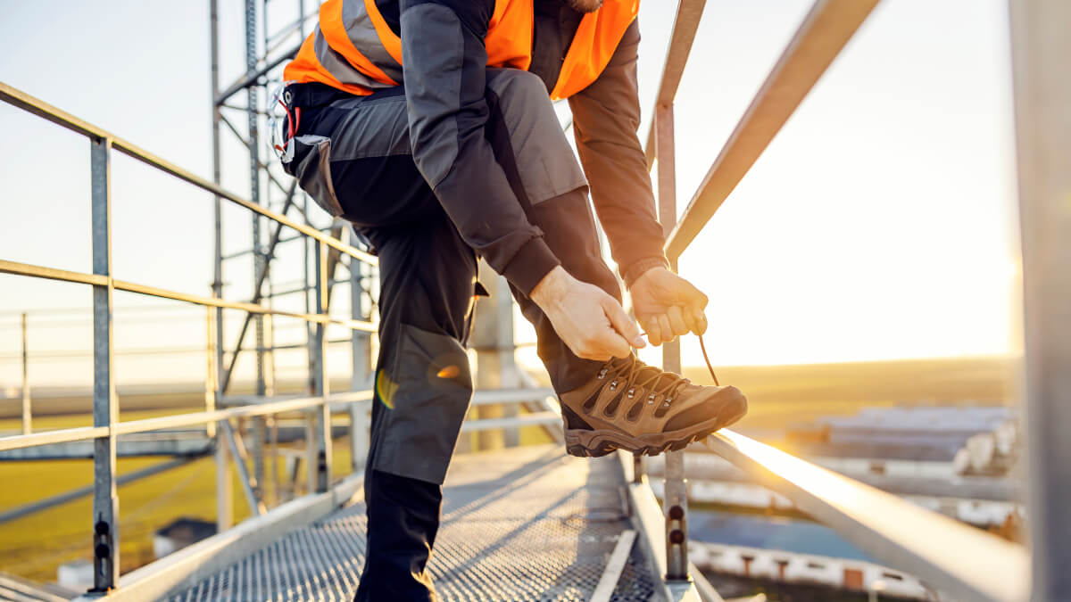 Construction worker tying laces